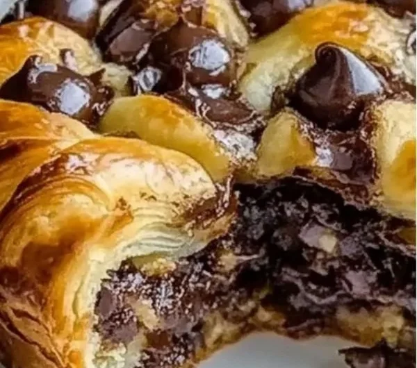 Freshly baked chocolate croissants with a rich chocolate filling