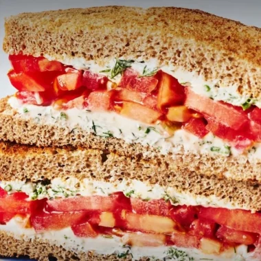 Delicious Classic Tomato Sandwich with fresh ingredients on a wooden plate