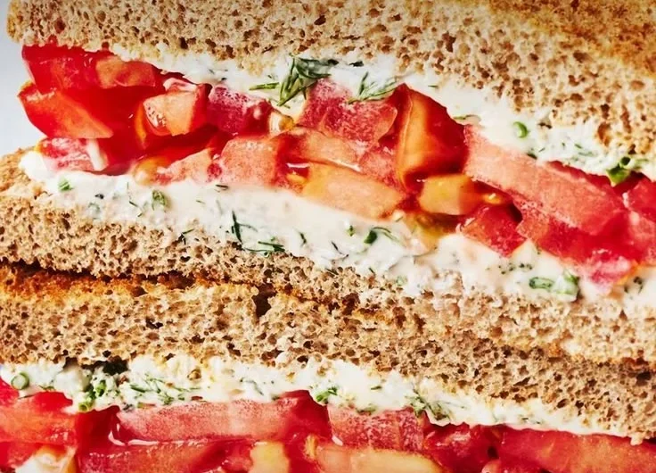 Delicious Classic Tomato Sandwich with fresh ingredients on a wooden plate