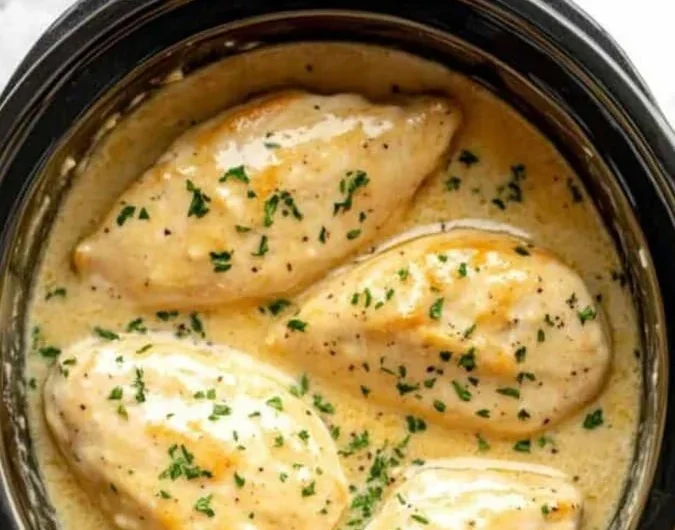 Crockpot Creamy Garlic Parmesan Chicken dish served with herbs