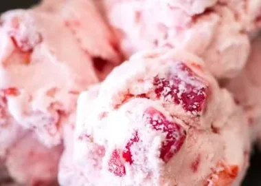 Delicious homemade strawberry ice cream in a bowl garnished with fresh strawberries
