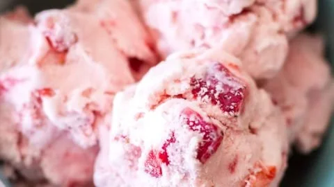 Delicious homemade strawberry ice cream in a bowl garnished with fresh strawberries