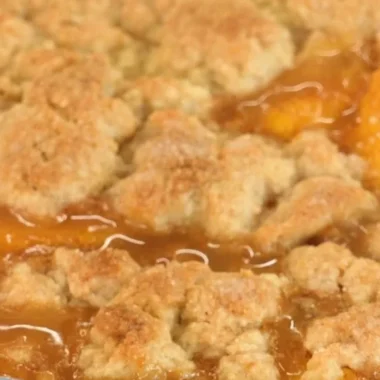 Delicious homemade peach cobbler with fresh peaches and a golden crust