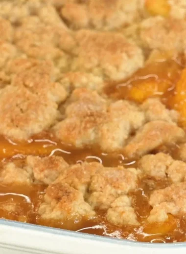 Delicious homemade peach cobbler with fresh peaches and a golden crust