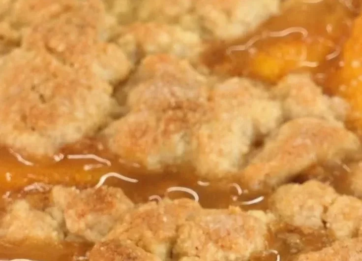 Delicious homemade peach cobbler with fresh peaches and a golden crust