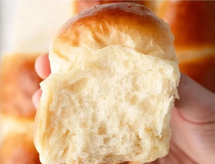 Freshly baked Sweet Hawaiian Bread Rolls on a wooden serving board