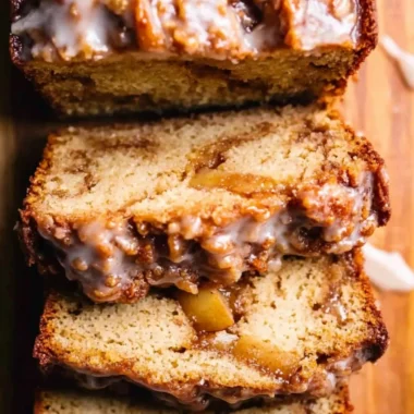 Amish apple fritter bread with apples and cinnamon on a wooden table