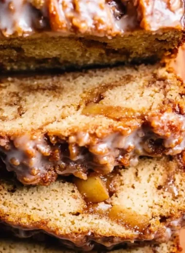 Amish apple fritter bread with apples and cinnamon on a wooden table