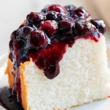Delicious slice of homemade Angel Food Cake with fresh strawberries on top