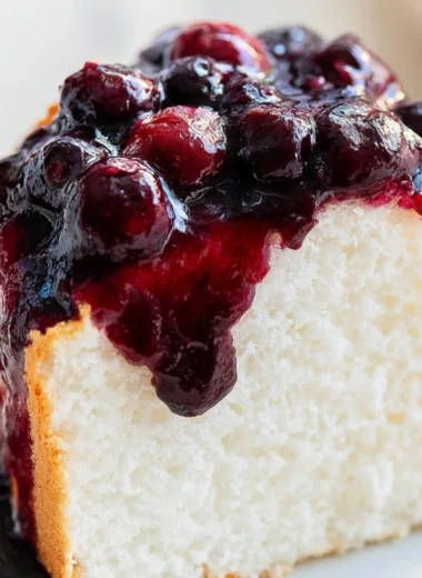 Delicious slice of homemade Angel Food Cake with fresh strawberries on top