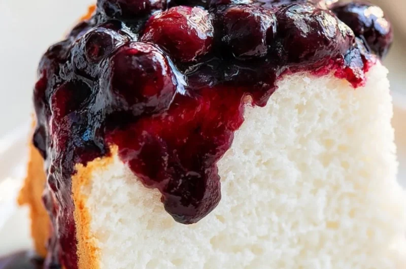 Delicious slice of homemade Angel Food Cake with fresh strawberries on top