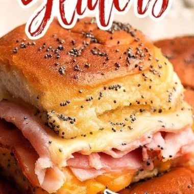 Baked ham and cheese sliders fresh out of the oven, melted cheese and golden crust.