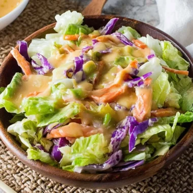 A bowl of fresh salad drizzled with Benihana Ginger Salad Dressing.