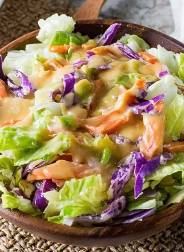 A bowl of fresh salad drizzled with Benihana Ginger Salad Dressing.