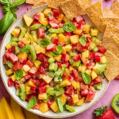 Bowl of fresh fruit salsa with a side of cinnamon sugar chips for dipping.