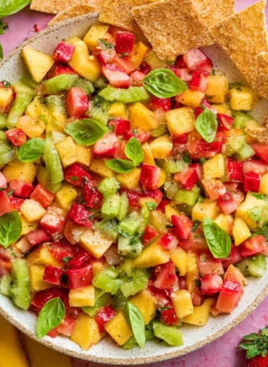 Bowl of fresh fruit salsa with a side of cinnamon sugar chips for dipping.