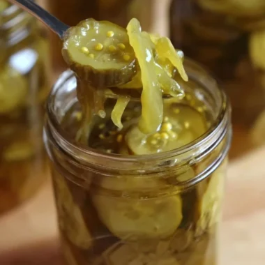Delicious homemade bread and butter pickles in a glass jar.