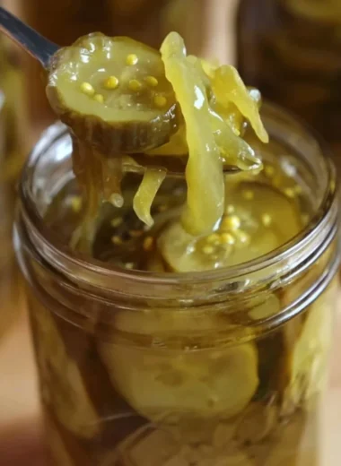 Delicious homemade bread and butter pickles in a glass jar.
