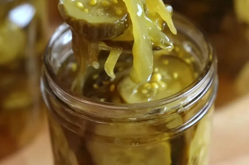 Delicious homemade bread and butter pickles in a glass jar.