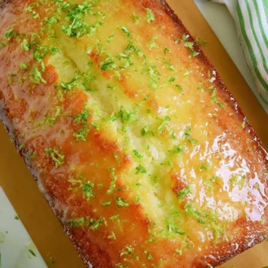 Delicious Key Lime Pound Cake sliced on a plate with a lime garnish