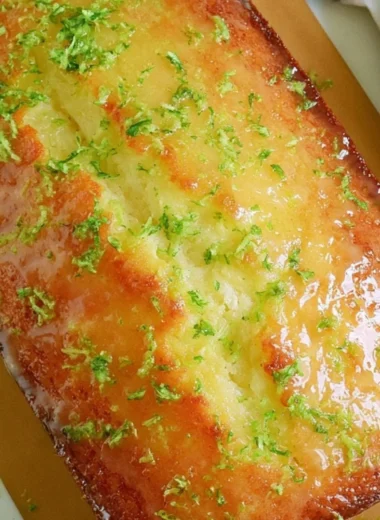 Delicious Key Lime Pound Cake sliced on a plate with a lime garnish