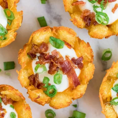 Delicious loaded tater tots topped with cheese, bacon, and green onions.