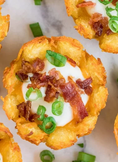 Delicious loaded tater tots topped with cheese, bacon, and green onions.