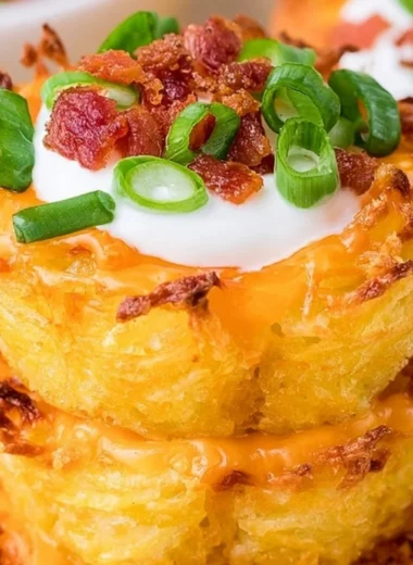Loaded tater tots topped with cheese, bacon, and green onions