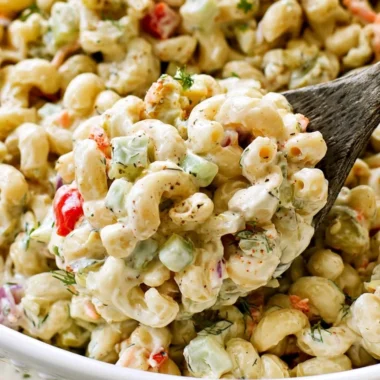Delicious macaroni salad served in a bowl with colorful vegetables