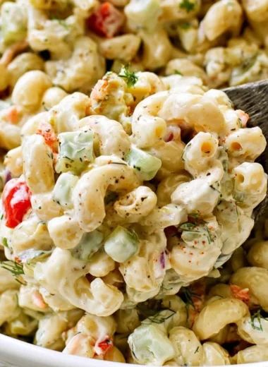 Delicious macaroni salad served in a bowl with colorful vegetables