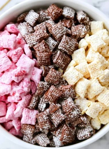 Neapolitan Puppy Chow dessert with chocolate, vanilla, and strawberry flavors.