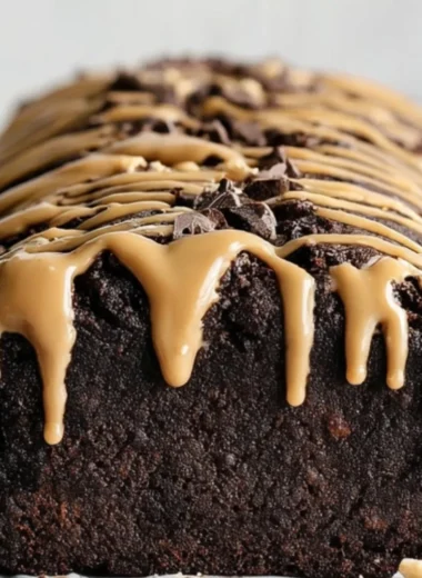Delicious peanut butter chocolate banana bread slice on a wooden board.