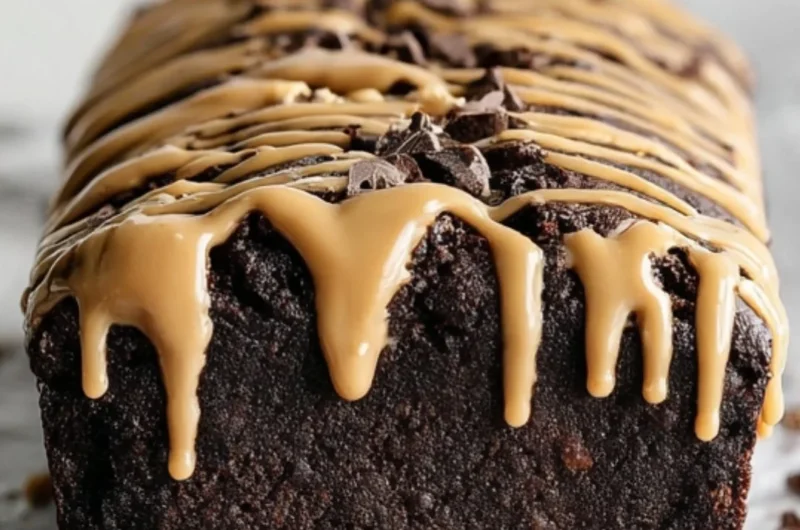 Delicious peanut butter chocolate banana bread slice on a wooden board.