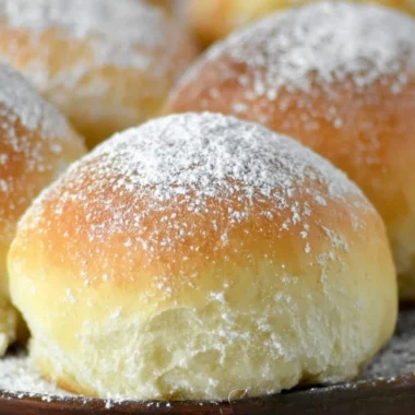 Freshly baked potato rolls served warm on a rustic wooden table
