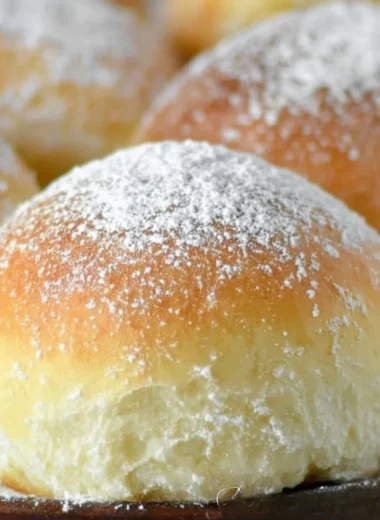 Freshly baked potato rolls served warm on a rustic wooden table