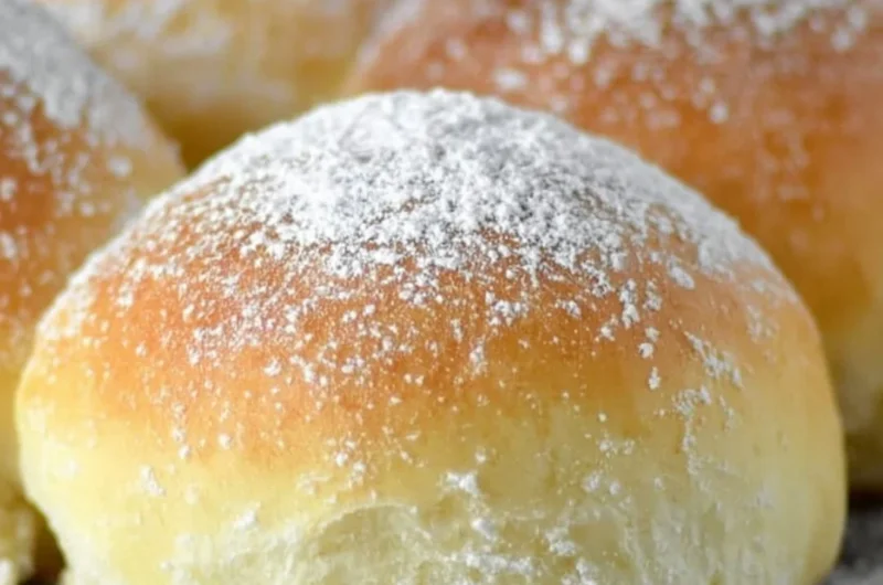 Freshly baked potato rolls served warm on a rustic wooden table