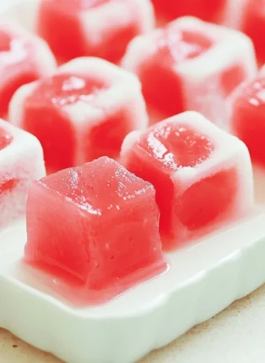 Delicious watermelon mochi dessert showcasing a pink and green color palette.