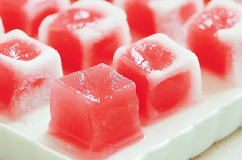 Delicious watermelon mochi dessert showcasing a pink and green color palette.