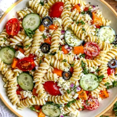 A delicious pasta salad featuring fresh vegetables, ideal for summer gatherings