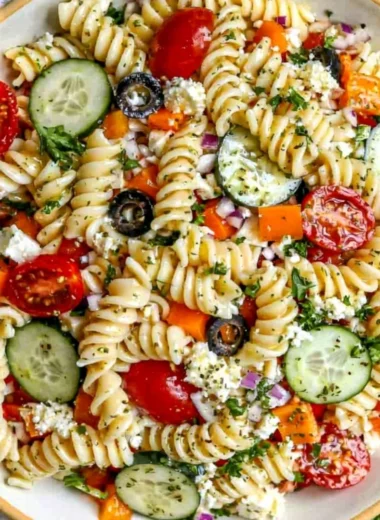 A delicious pasta salad featuring fresh vegetables, ideal for summer gatherings