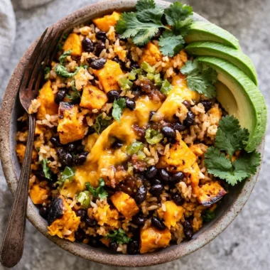 Delicious Southwest sweet potato, black bean, and rice skillet in a cast-iron pan.