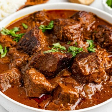 Cozy beef vindaloo dish served in a bowl with spices and herbs