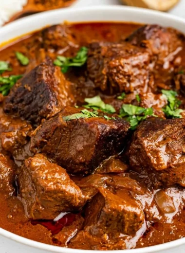 Cozy beef vindaloo dish served in a bowl with spices and herbs