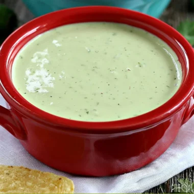 Bowl of creamy jalapeño dip served with tortilla chips