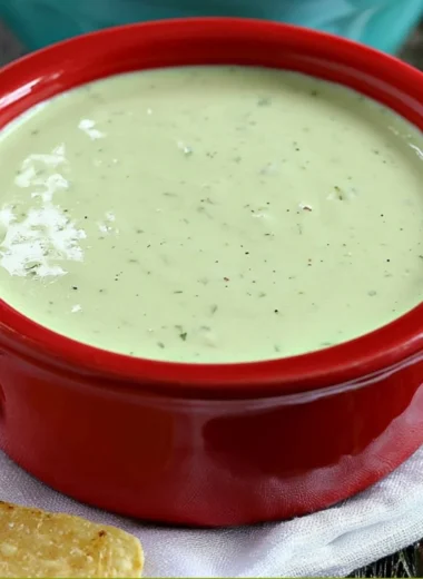 Bowl of creamy jalapeño dip served with tortilla chips