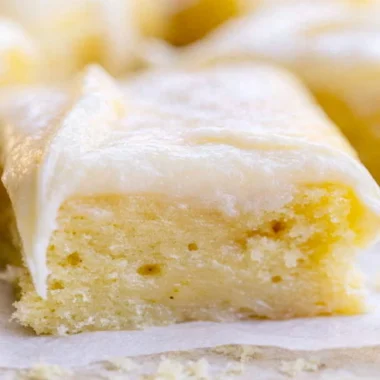 Cozy White Texas Sheet Cake served on a plate with a slice cut out
