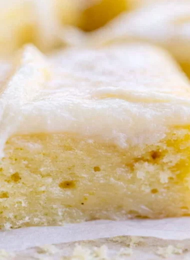 Cozy White Texas Sheet Cake served on a plate with a slice cut out