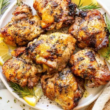 Lemon and garlic Greek marinated chicken served with fresh herbs on a plate