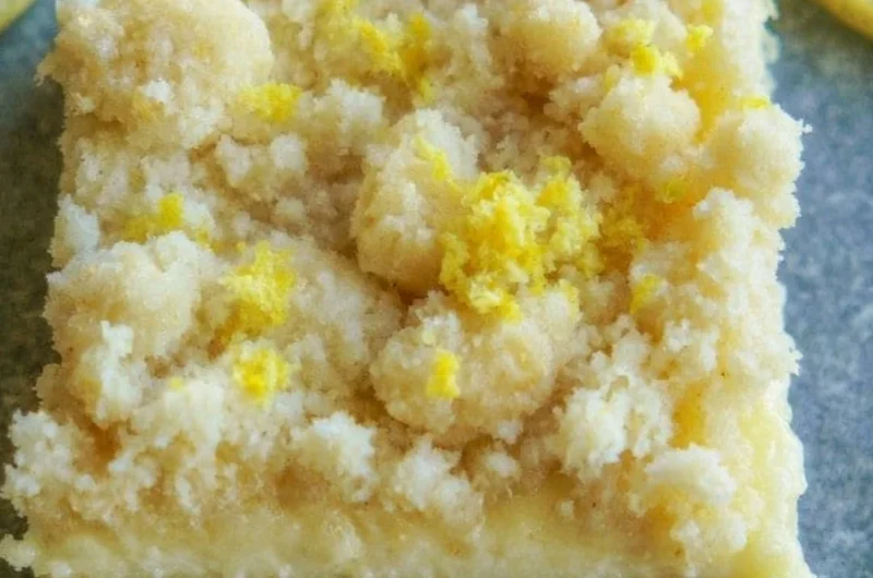 Delicious lemon sugar cookie bars topped with lemon zest and sugar.