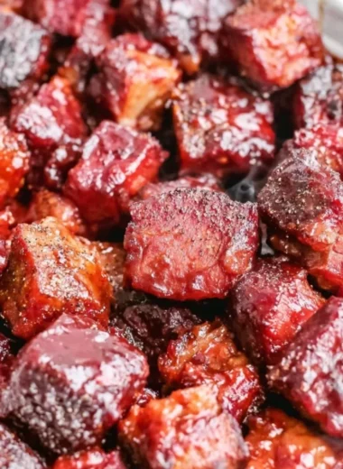 Delicious Poor Man's Burnt Ends served on a plate with BBQ sauce.